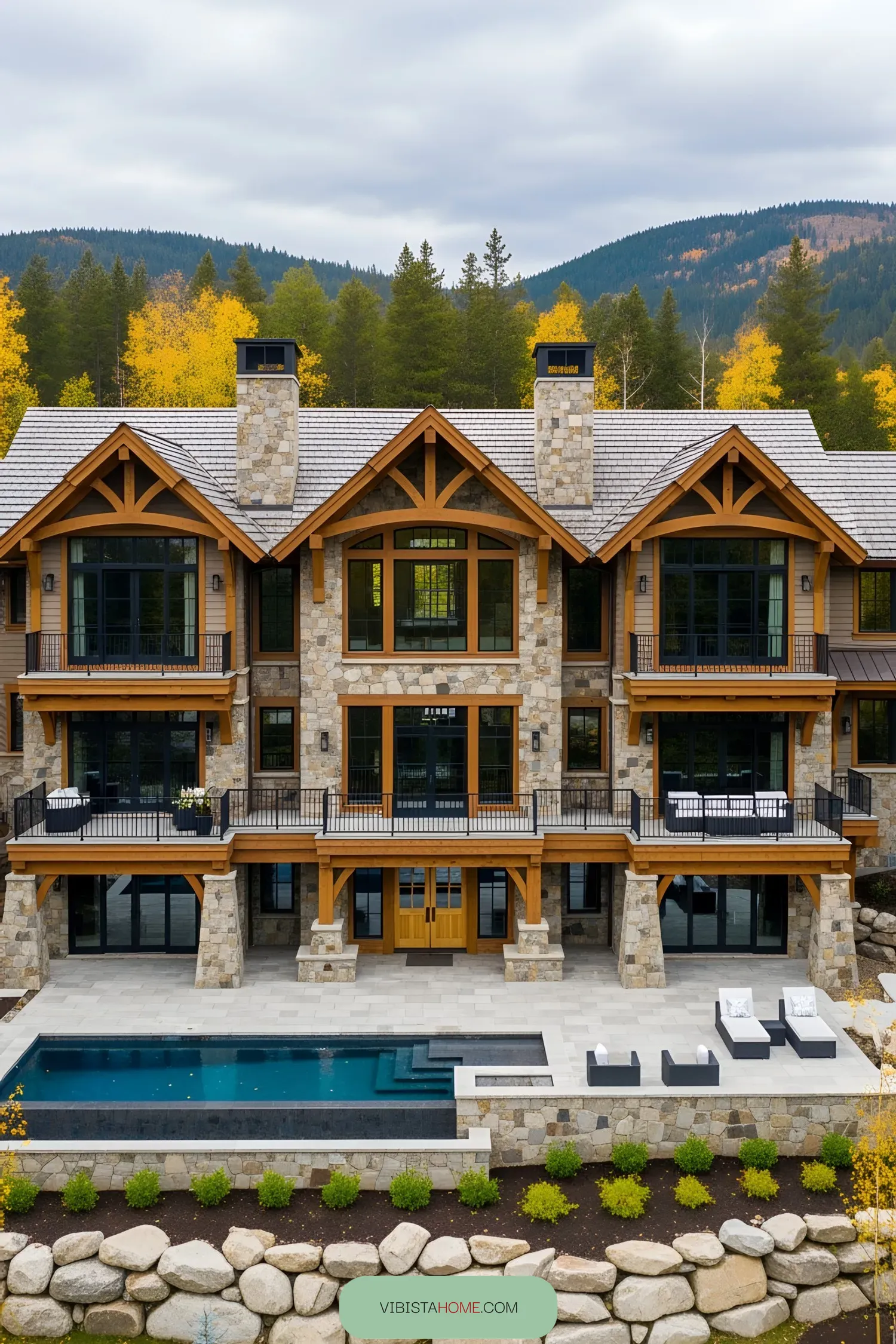 Spacious stone lodge with large windows and a pool