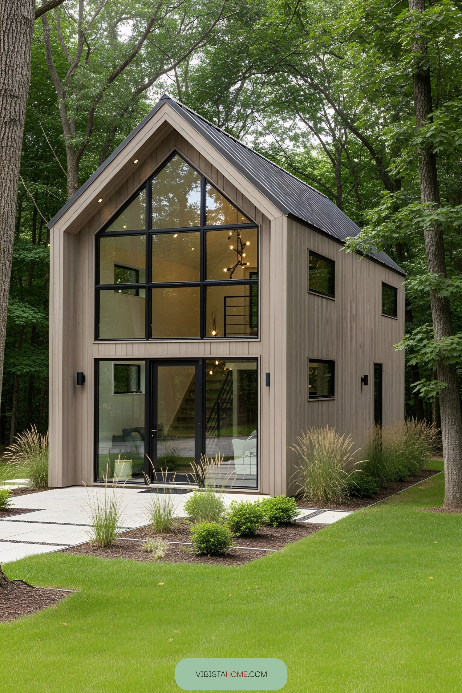 Compact house with tall windows in a wooded setting