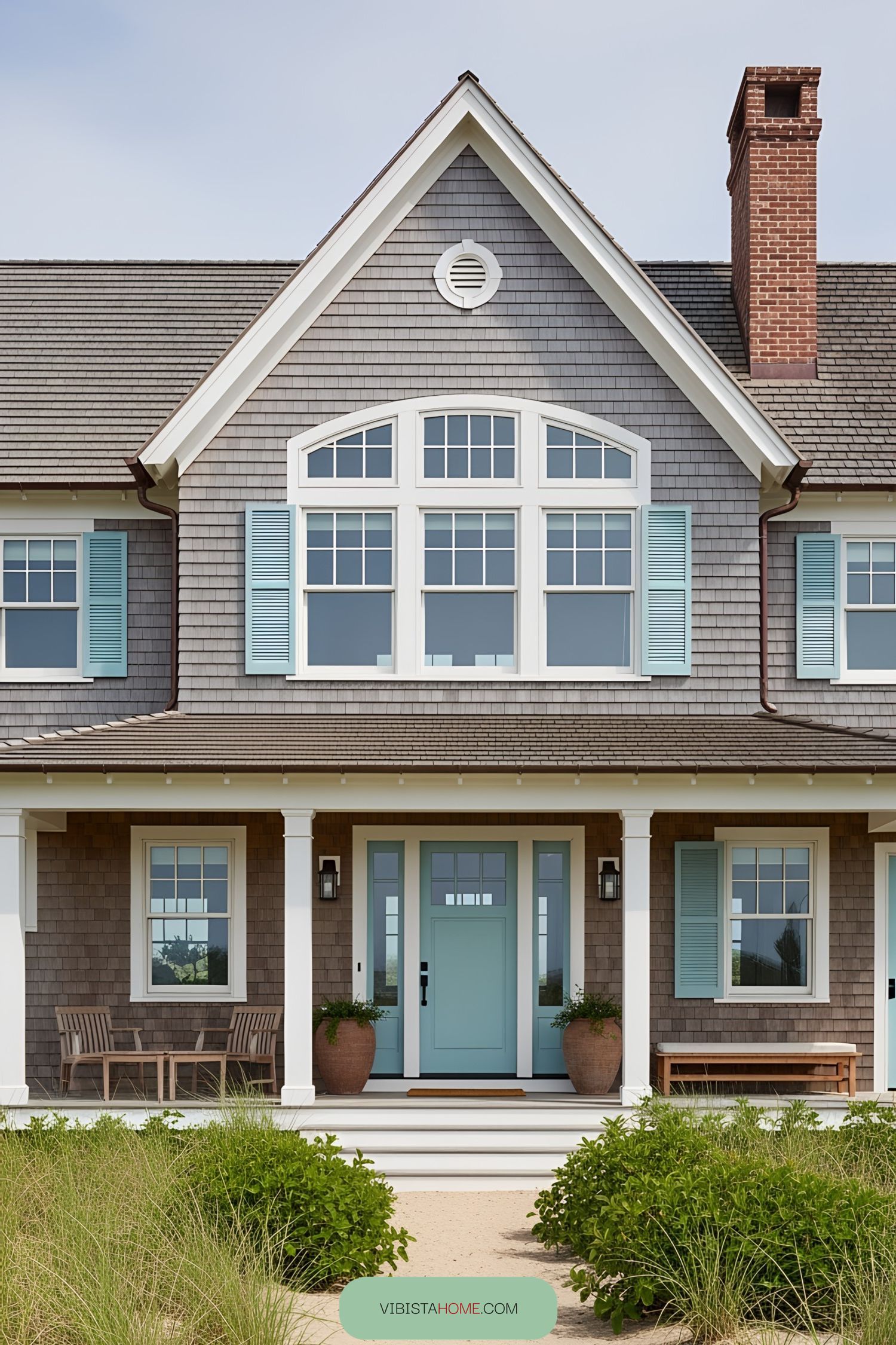 Charming coastal home with pastel shutters and a warm, inviting entrance