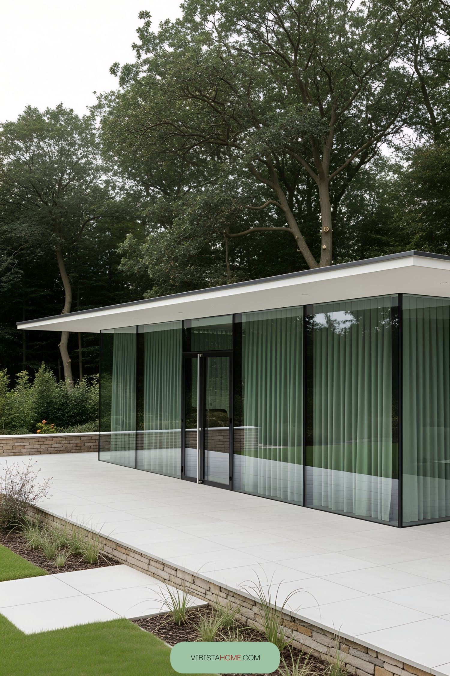 Flat modern glass terrace surrounded by lush greenery