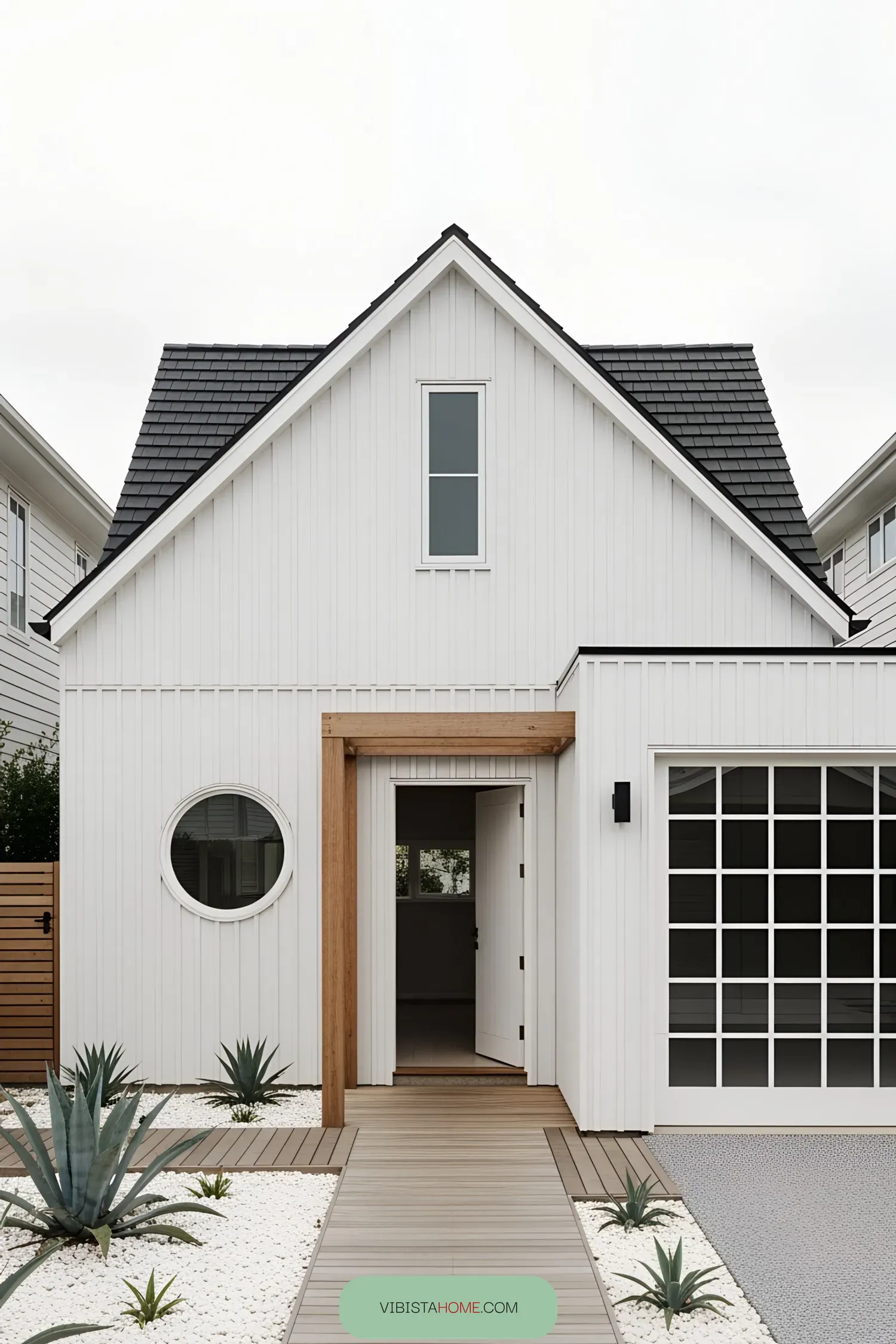 White beach house facade with circular window and wooden accents