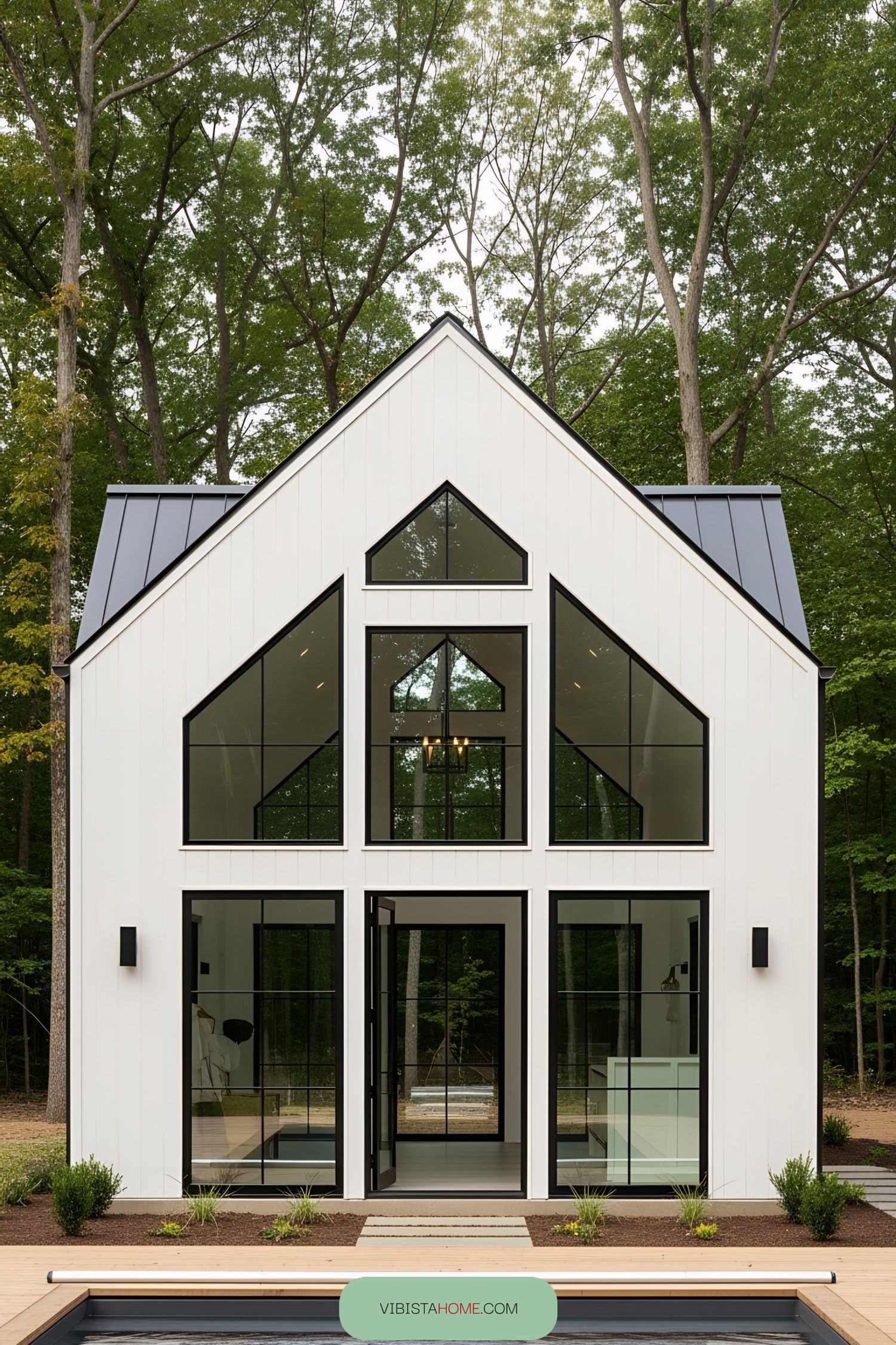 Modern pool house with large windows nestled in a forest setting