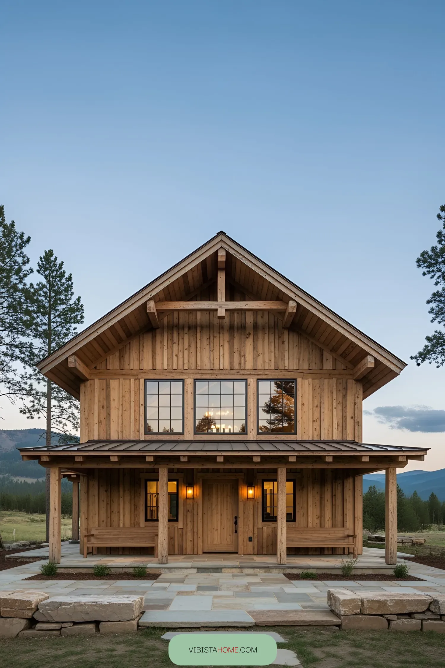 Wooden lodge with large windows and mountain backdrop