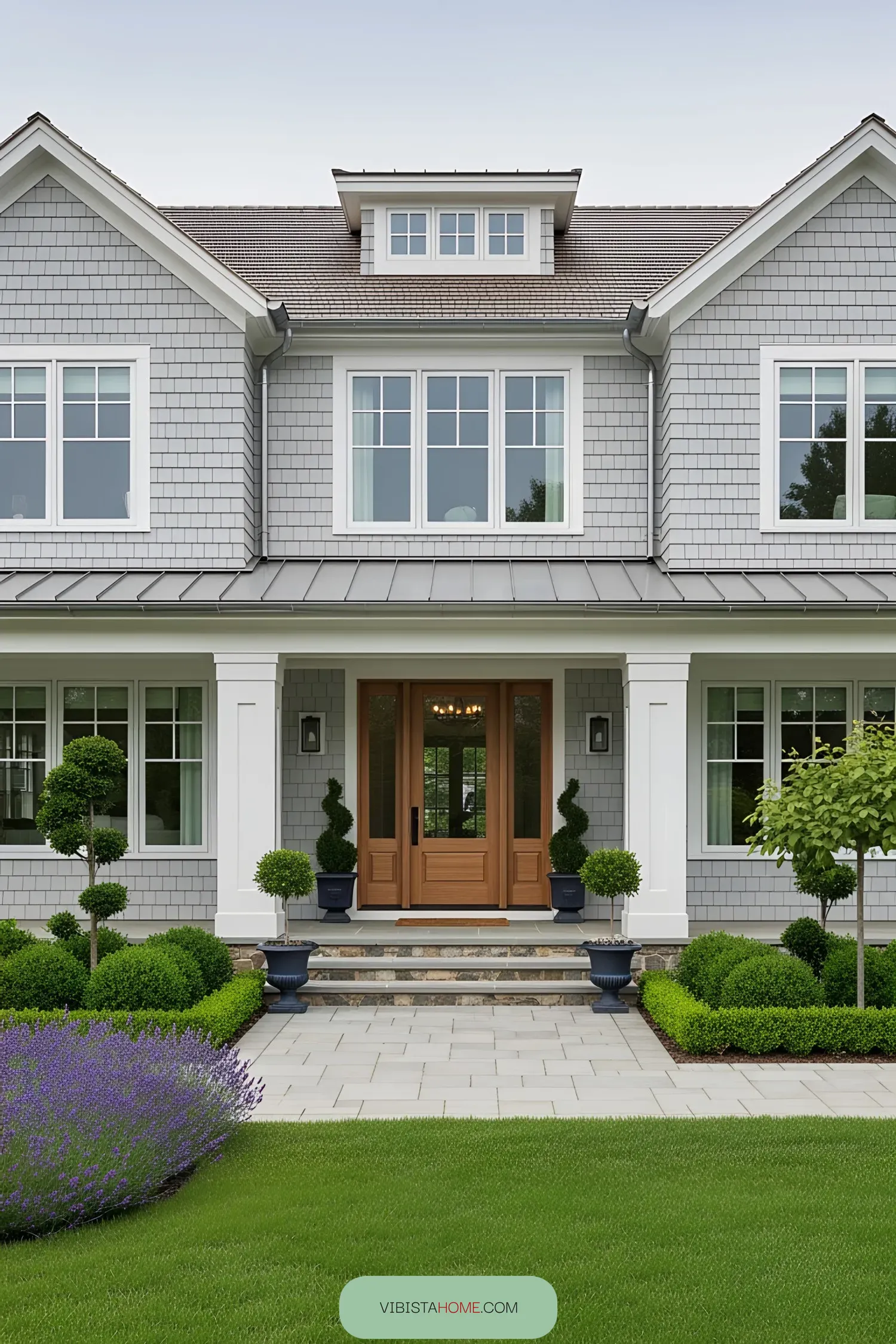 Modern coastal home with lush greenery and elegant entryway