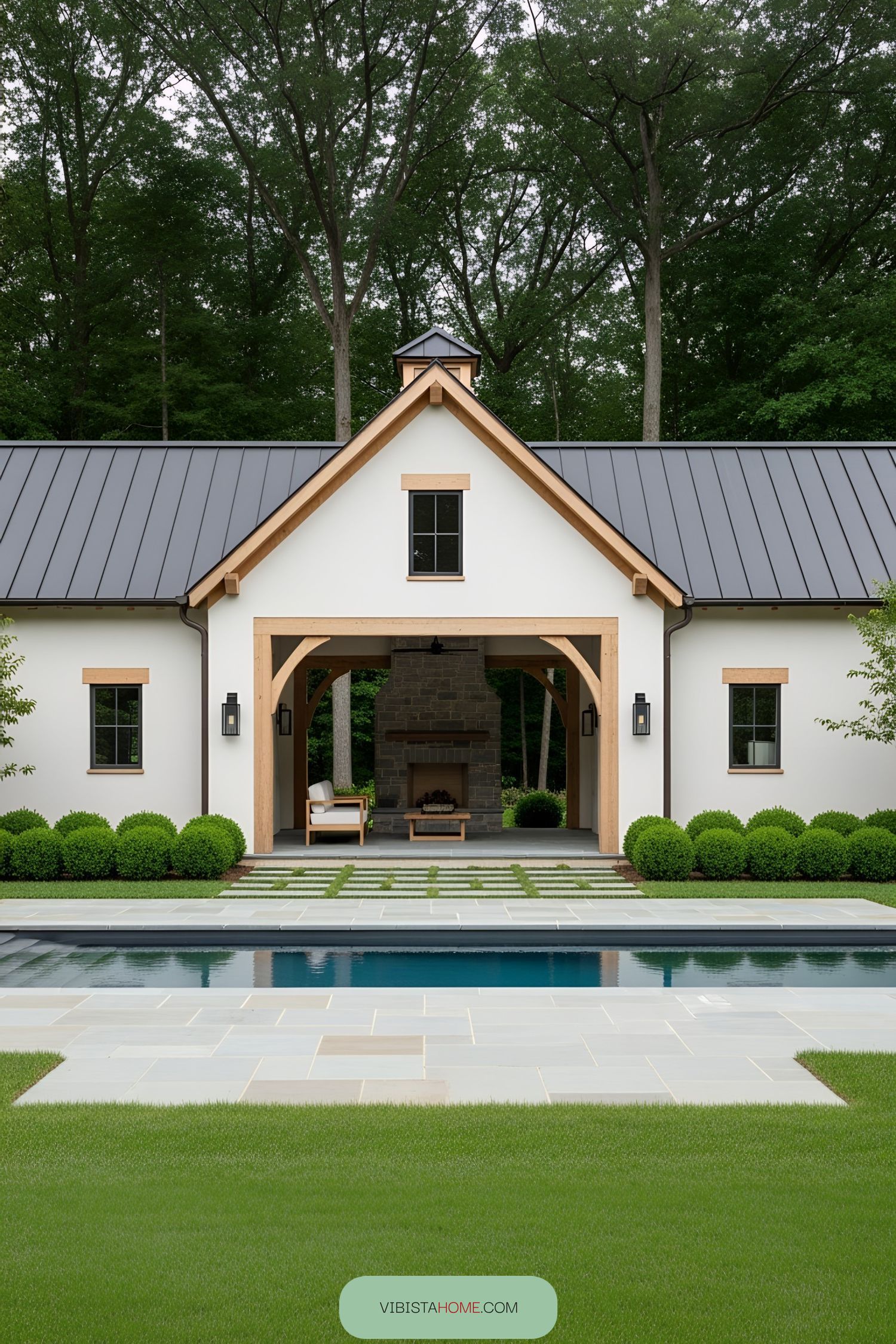 Rustic barn pool house with modern flair and inviting fireplace