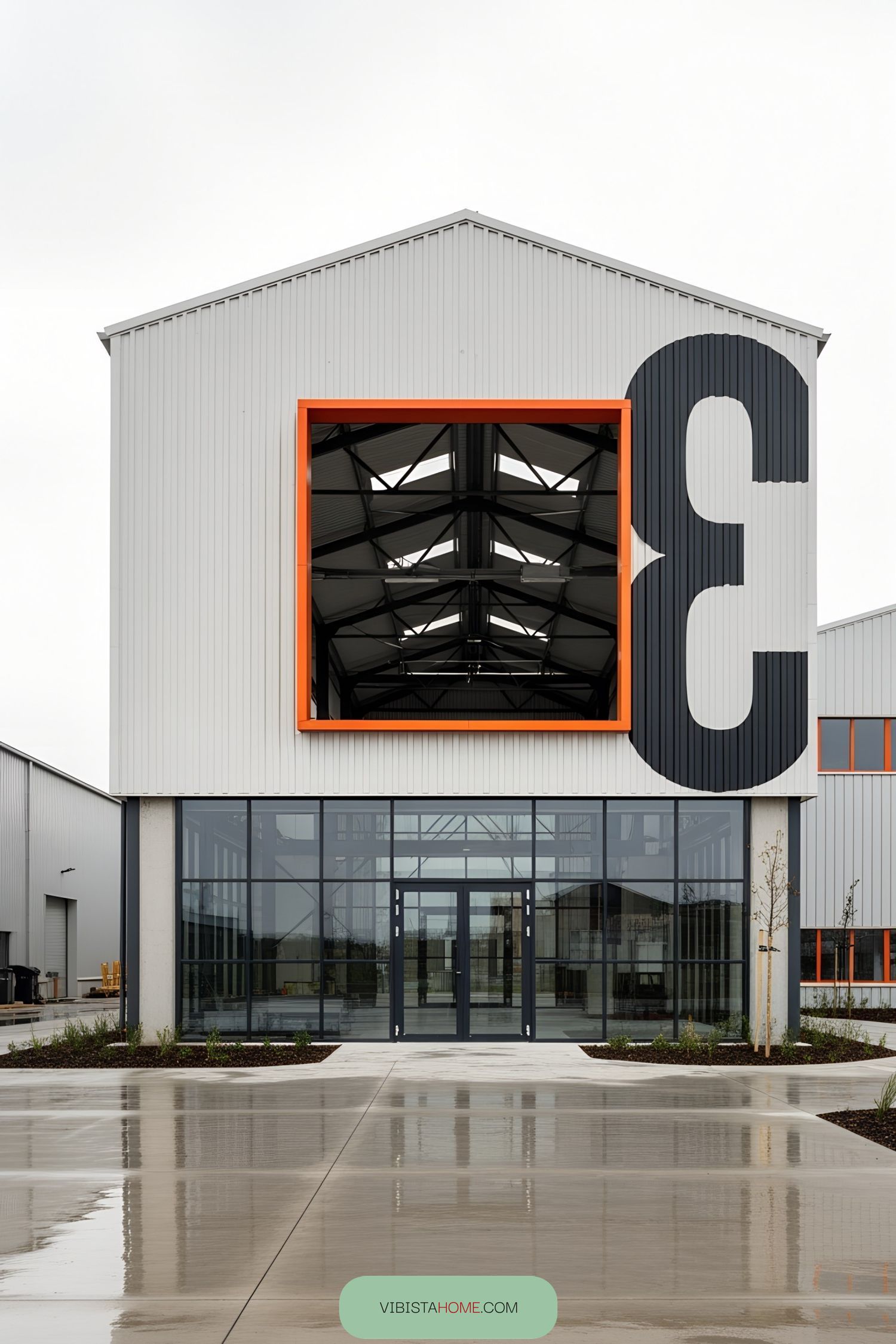 Facade of a modern industrial building with large number 3 and orange accents