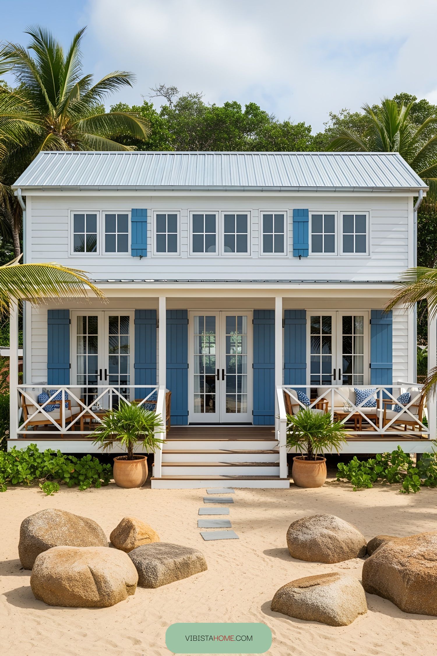 Charming rustic beach house with blue shutters and palm trees