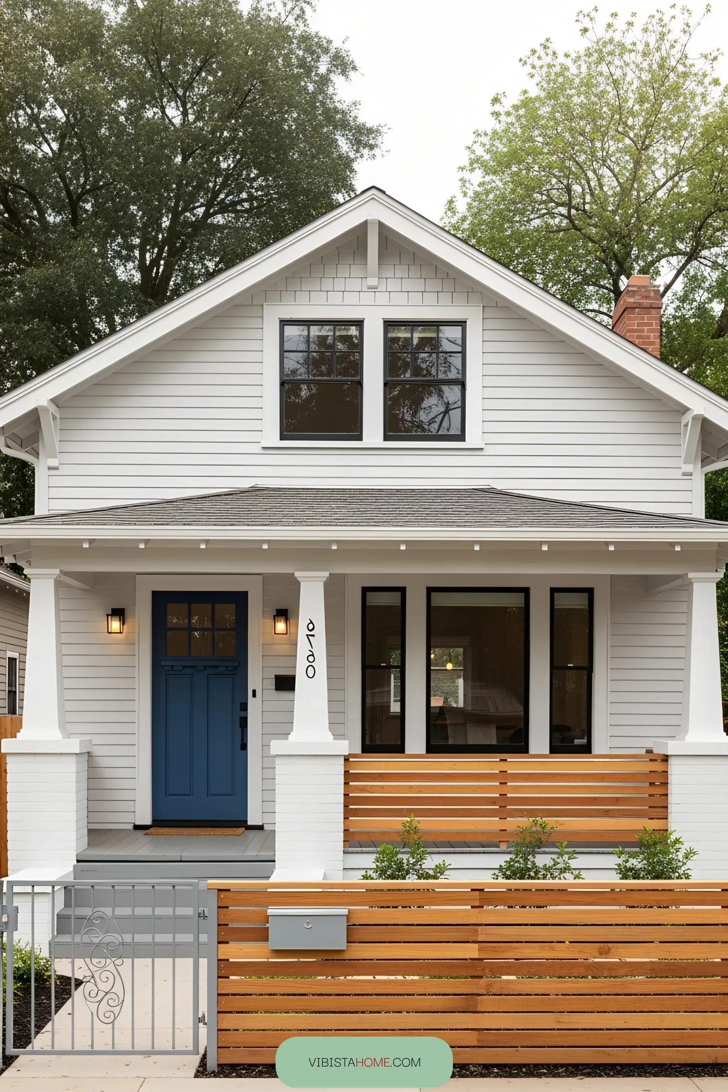 Charming 1930s bungalow with white facade and blue door